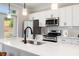 Modern kitchen with white cabinets, stainless steel appliances and kitchen island at 1526 Burberry Aly, Marietta, GA 30008