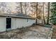 Backyard view showing a large concrete slab and surrounding trees at 329 Mount Zion Sw Rd, Atlanta, GA 30354