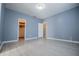 Spacious bedroom with light gray flooring and a walk-in closet at 7169 Woodridge Ln, Union City, GA 30291