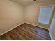 Bright bedroom with wood-look floors and window blinds at 10311 Commons Xing, Jonesboro, GA 30238