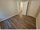 Spacious bedroom featuring wood-look floors and access to hallway at 10311 Commons Xing, Jonesboro, GA 30238