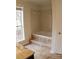 Bathroom with built-in bathtub and tile flooring at 2688 Crystal Ln, Lawrenceville, GA 30044