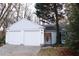 Three-car garage, white exterior, landscaping at 2688 Crystal Ln, Lawrenceville, GA 30044
