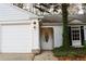 White exterior, front door entry, landscaping at 2688 Crystal Ln, Lawrenceville, GA 30044