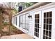 White house exterior with French doors and deck, surrounded by mature trees at 2688 Crystal Ln, Lawrenceville, GA 30044