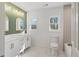 Modern bathroom with double vanity, green accent wall, and marble-look tile at 2756 Lincoln Nw Ct, Atlanta, GA 30318