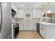 Modern kitchen with white shaker cabinets, quartz countertops, and stainless steel appliances at 2756 Lincoln Nw Ct, Atlanta, GA 30318