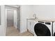 Convenient laundry room with washer, dryer, and utility sink at 2756 Lincoln Nw Ct, Atlanta, GA 30318