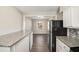 Modern kitchen featuring granite countertops and white cabinets at 1620 Flintwood Se Dr, Atlanta, GA 30316