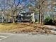 Two-story house with front porch and mature trees at 627 Huntington Nw Way, Lilburn, GA 30047