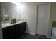 Double vanity bathroom with dark brown cabinets and a garden tub at 1180 Hartwell Rd, Locust Grove, GA 30248