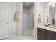 Bathroom with walk-in shower, hexagon floor tile, and dark brown vanity at 195 Brookhollow Trce, Johns Creek, GA 30022