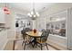 Bright dining room with a table and chairs, and view of sunroom at 195 Brookhollow Trce, Johns Creek, GA 30022