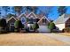 Two-story house with stone accents and manicured lawn at 195 Brookhollow Trce, Johns Creek, GA 30022