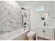 Clean bathroom with white vanity, bathtub, and marble shower surround at 2208 Baker Nw Rd, Atlanta, GA 30318