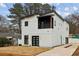 Modern two-story house with white siding, black accents, and a attached garage at 2208 Baker Nw Rd, Atlanta, GA 30318