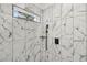 Walk-in shower with marble tile and modern fixtures at 2208 Baker Nw Rd, Atlanta, GA 30318