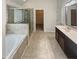 Main bathroom with soaking tub and walk-in shower at 607 Stream Ct, Fairburn, GA 30213