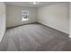 Spacious bedroom with grey carpet and a large window at 607 Stream Ct, Fairburn, GA 30213