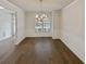 Formal dining room featuring hardwood floors and chandelier at 607 Stream Ct, Fairburn, GA 30213