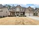 Brick two-story house with a front porch and attached two-car garage at 607 Stream Ct, Fairburn, GA 30213