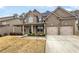 Brick two-story house with a front porch and attached two-car garage at 607 Stream Ct, Fairburn, GA 30213