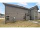 Gray siding two story house with a small backyard at 607 Stream Ct, Fairburn, GA 30213