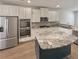 Modern kitchen with stainless steel appliances and granite island at 607 Stream Ct, Fairburn, GA 30213