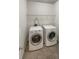Laundry room with washer, dryer, and overhead shelving at 607 Stream Ct, Fairburn, GA 30213