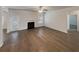 Spacious living room featuring hardwood floors and a fireplace at 607 Stream Ct, Fairburn, GA 30213