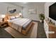 Virtually staged main bedroom with a large bed and neutral decor at 607 Stream Ct, Fairburn, GA 30213