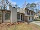 Two-story house with beige siding, brick accents, and a paved driveway at 6841 Cherry Log Pl, Austell, GA 30168