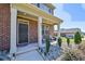 Front porch with seating area and landscaping at 1468 Harlequin Way, Stockbridge, GA 30281