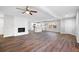 Spacious living area with hardwood floors, a brick fireplace, and an open floor plan at 3599 Dial Dr, Stone Mountain, GA 30083