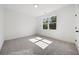 Bright bedroom with grey carpet and large window at 2587 Kingsley Ne Dr, Marietta, GA 30062