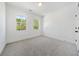 Well-lit bedroom featuring grey carpet and two windows at 2587 Kingsley Ne Dr, Marietta, GA 30062