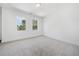 Spacious bedroom with grey carpet and two windows at 2587 Kingsley Ne Dr, Marietta, GA 30062