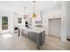 Modern kitchen with white cabinets, gray island, and gold pendant lights at 2587 Kingsley Ne Dr, Marietta, GA 30062
