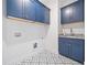 Laundry room with blue cabinets and patterned tile floor at 2587 Kingsley Ne Dr, Marietta, GA 30062
