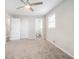 Spacious bedroom with neutral walls and carpet, featuring a ceiling fan and private access to the bathroom at 3686 Thurman Rd, Atlanta, GA 30349