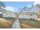 Ranch style home with a red door and landscaped yard at 3686 Thurman Rd, Atlanta, GA 30349