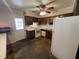 Galley kitchen with wood cabinets, white appliances, and access to backyard at 3825 Lavista Rd # Q3, Tucker, GA 30084