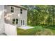 Home with private backyard, patio, and white vinyl fence. Wooded area in background at 1080 Cades Walk, Lawrenceville, GA 30045