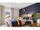 Cozy bedroom with wood bed frame and navy blue accent wall at 1080 Cades Walk, Lawrenceville, GA 30045