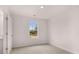 Bright bedroom with neutral walls, carpet, and a window at 1080 Cades Walk, Lawrenceville, GA 30045