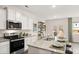 Modern kitchen with white cabinets, granite counters, and stainless steel appliances at 1080 Cades Walk, Lawrenceville, GA 30045