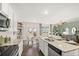 Open concept kitchen with island and view to living room at 1080 Cades Walk, Lawrenceville, GA 30045