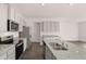 Modern kitchen featuring stainless steel appliances and granite countertops at 1080 Cades Walk, Lawrenceville, GA 30045