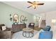 Spacious living room with hardwood floors, a ceiling fan, and access to the kitchen at 1080 Cades Walk, Lawrenceville, GA 30045