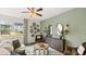 Cozy living room with a ceiling fan, stylish decor, and a view of the kitchen at 1080 Cades Walk, Lawrenceville, GA 30045